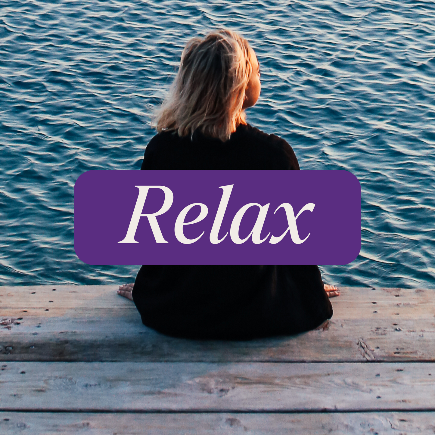 Person sitting by water with a purple banner that says 'Relax' in white lettering.