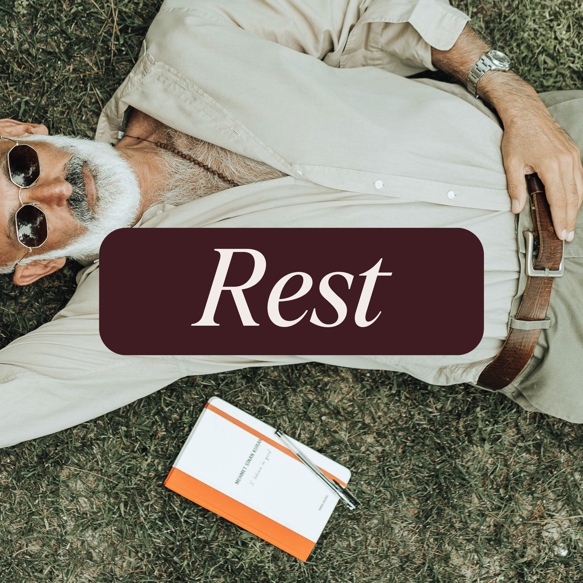 Man lying down next to a notebook. Purple banner with the word 'Rest' in white lettering.