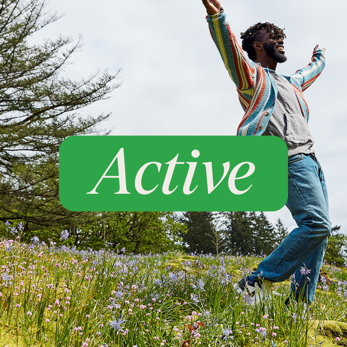 Person outdoors in a wildflower field with arms raised with 'Active' label overlay in green box.
