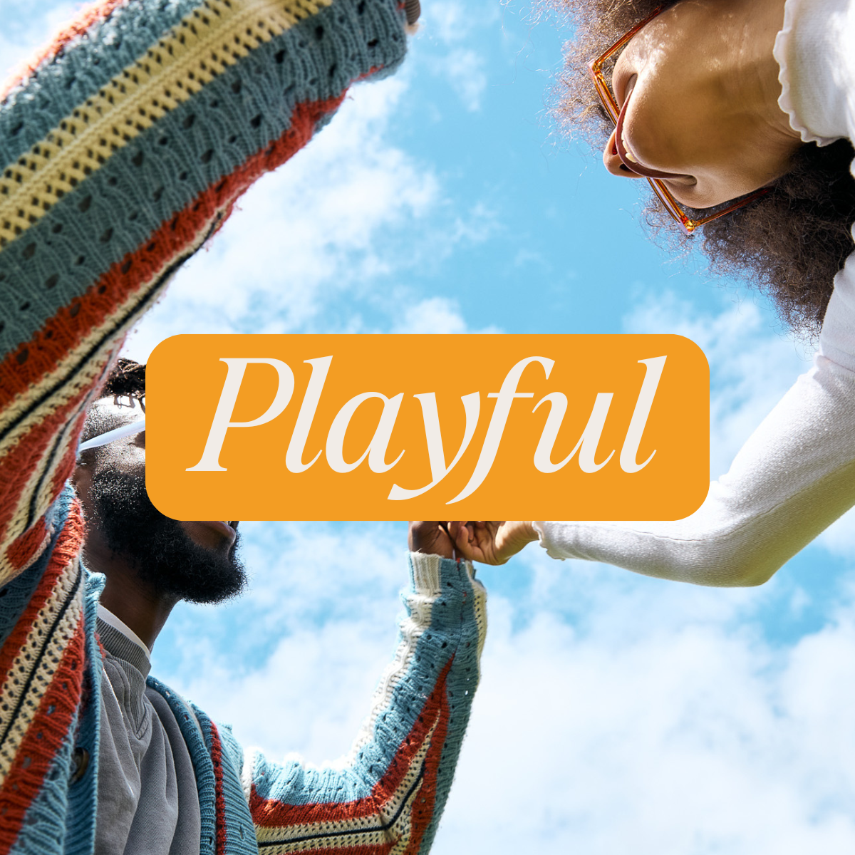 Two people interacting under a bright blue sky, one in a colorful striped sweater and the other in white clothing, with the word 'Playful' centered on an orange banner—evoking a joyful, lighthearted vibe.
