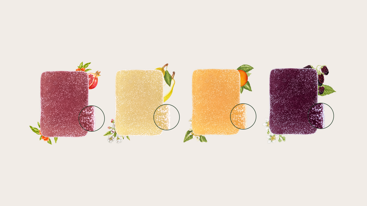 Four square fruit‑flavored cannabis gummies in red, yellow, orange, and dark purple, each surrounded by illustrated fruit and botanical ingredients with magnified sugar detail.